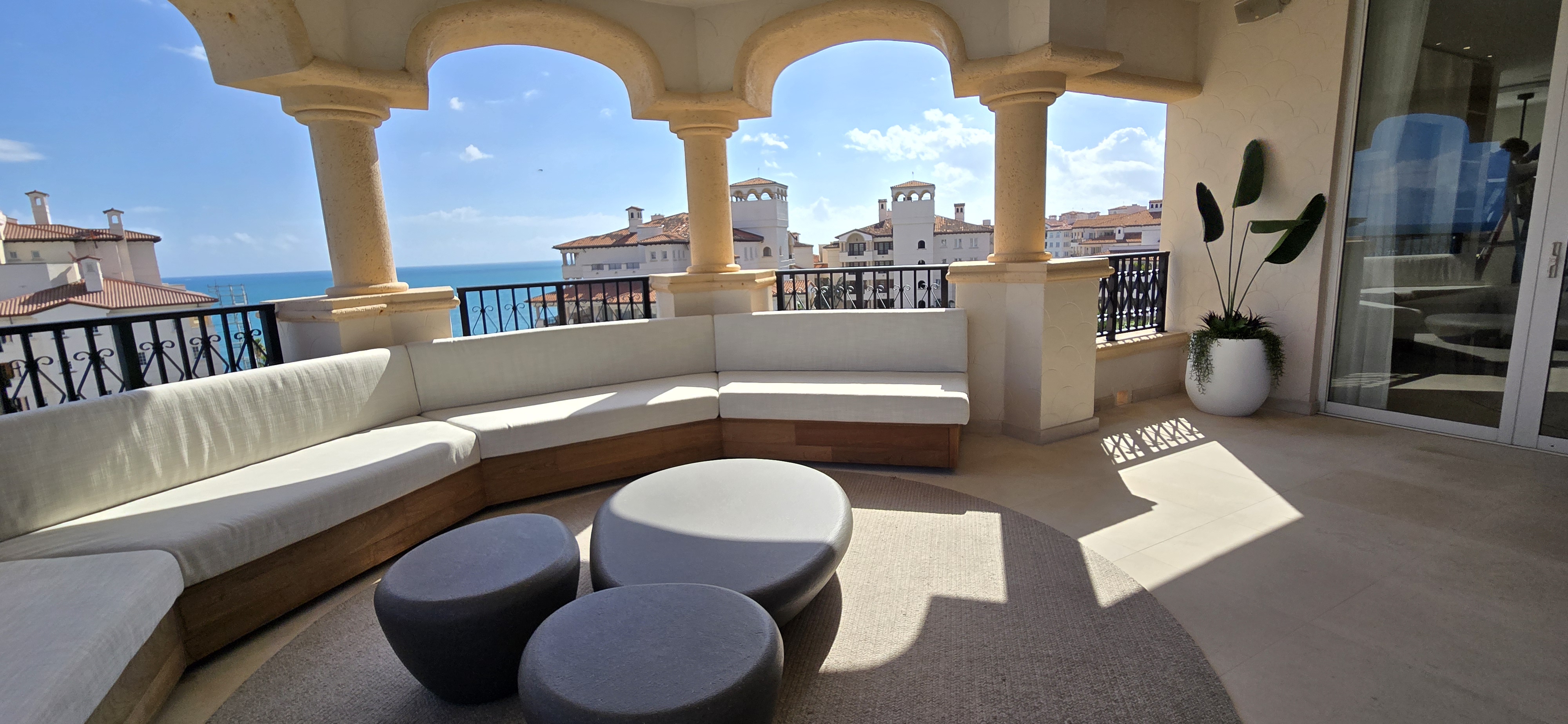 Fisher Island luxury terrace with custom curved built-in seating and ocean view