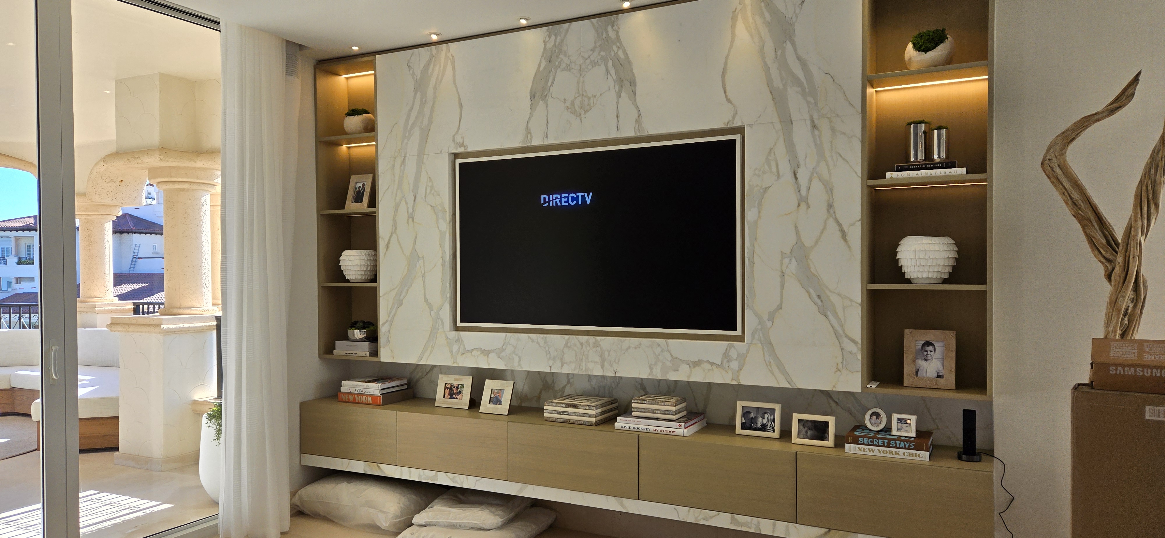Custom TV wall unit with marble and LED shelving