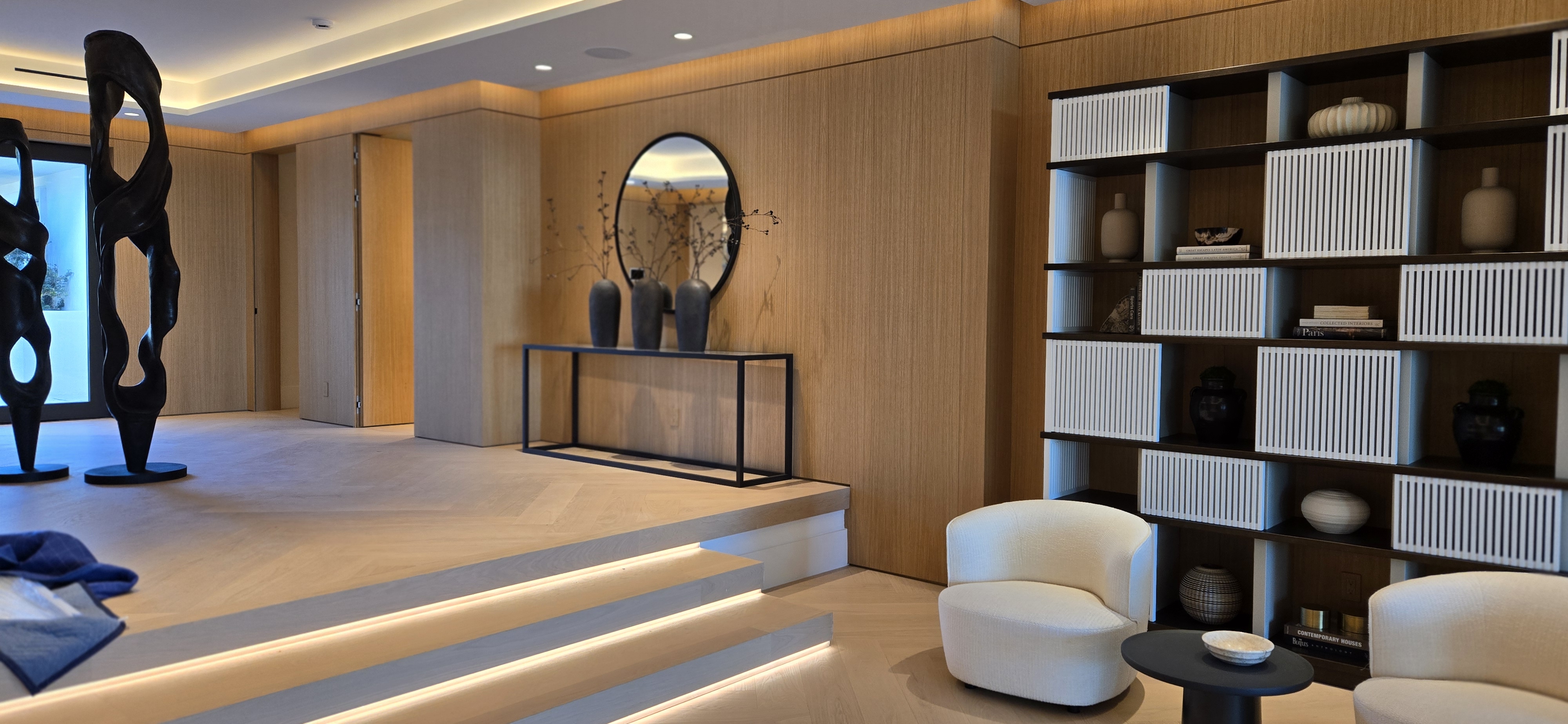 Full wood panel walls with custom bookcase and modern interior