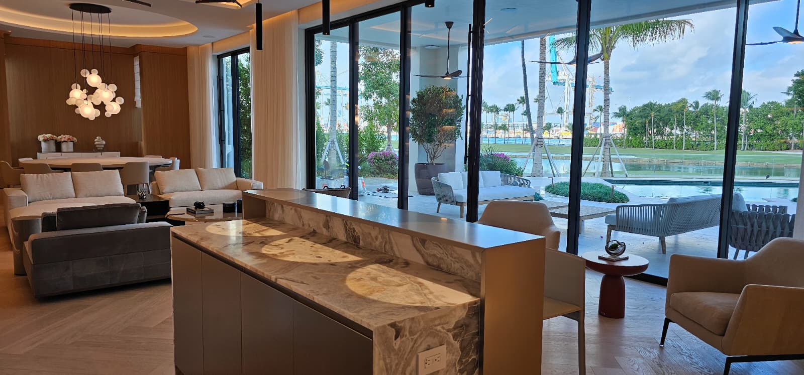 Luxury kitchen with waterfall marble island and pool view