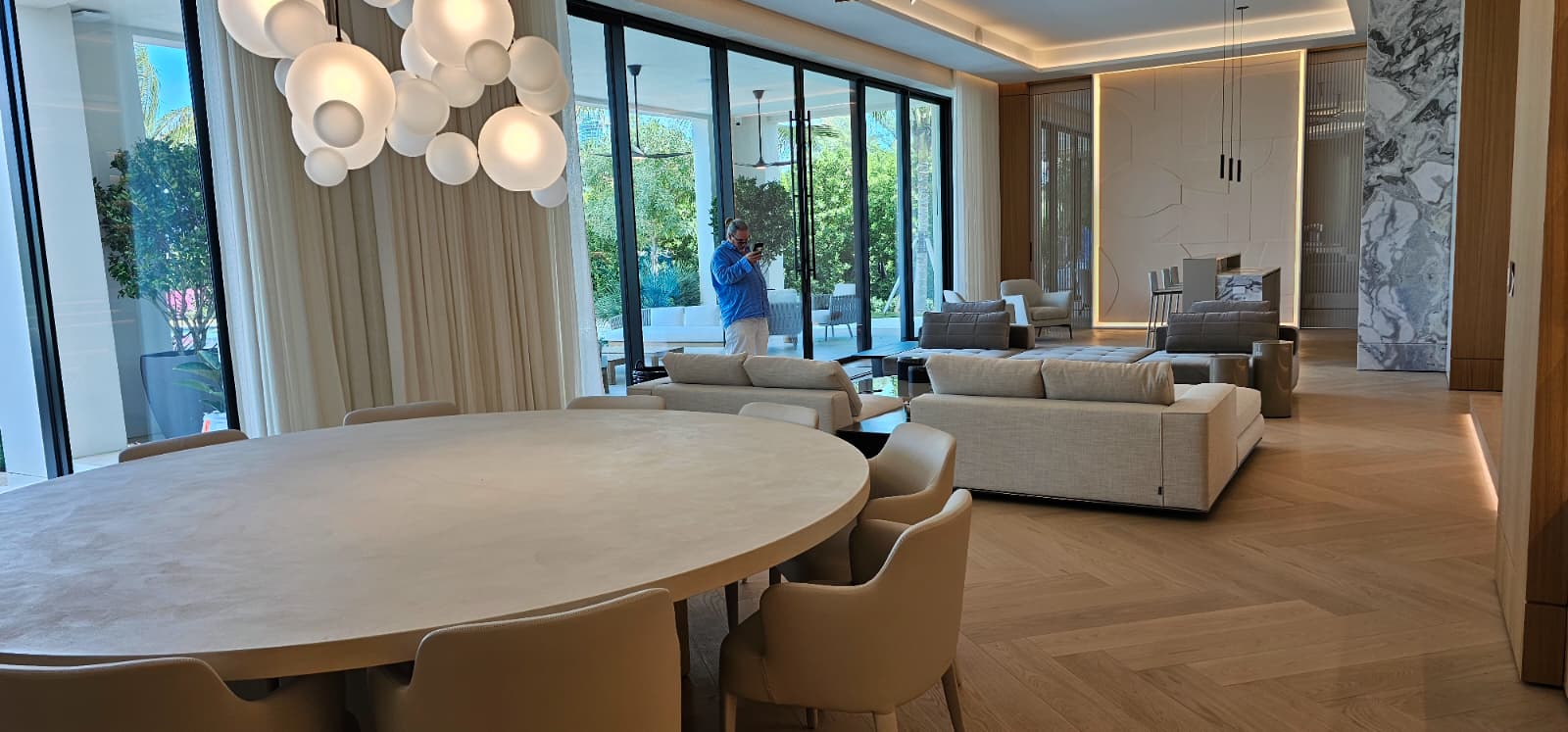 Luxury open-plan living and dining with wood accent walls
