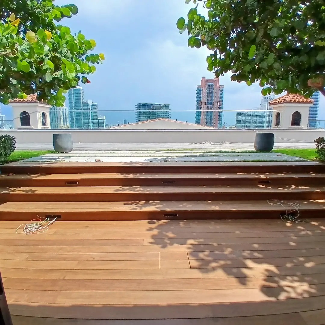 Rooftop hardwood deck with step detail and Miami skyline